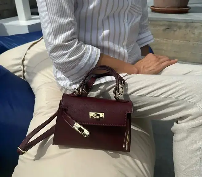 The bordeaux leather mini on a lap