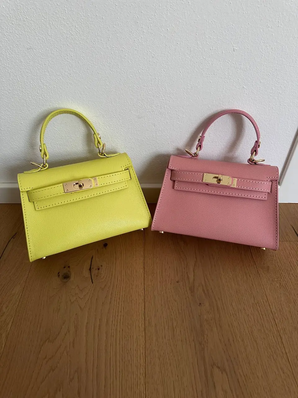 Butter yellow and baby pink leather minis side by side