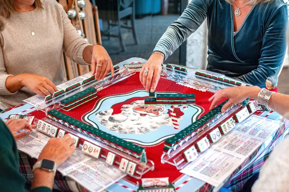 Friends playing mahjong on the Santa's Mail mat